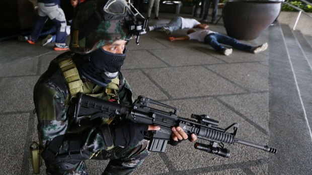 Members of the Philippine National Police Special Action Force conduct a raid to simulate an attack as part of heightened security efforts leading up to the APEC Summit in Manila.