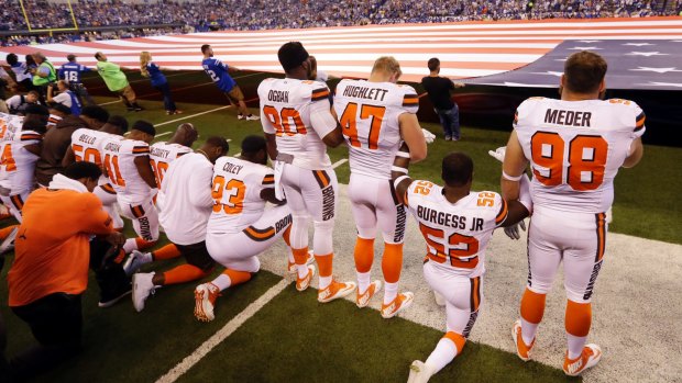 Members of the Cleveland Browns take a knee during the national anthem.