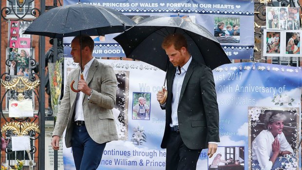 Britain's Prince William, left, and Prince Harry observed the tributes on Wednesday.