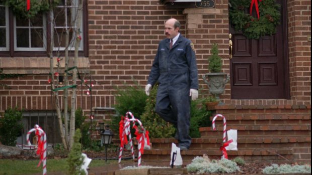 A Boulder Police Department detective leaves the home of John and Patsy Ramsey in this photo from January 3, 1997.