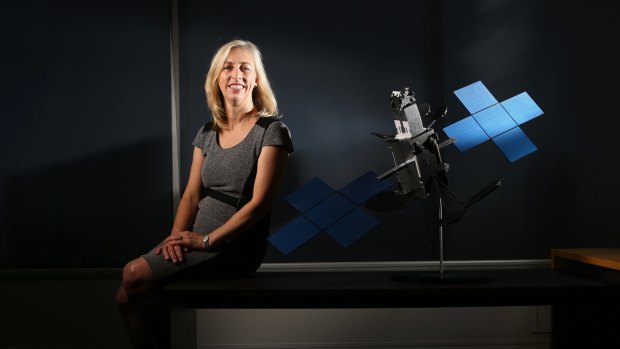 Satellite architect Julia Dickinson with a model of the broadband satellite.