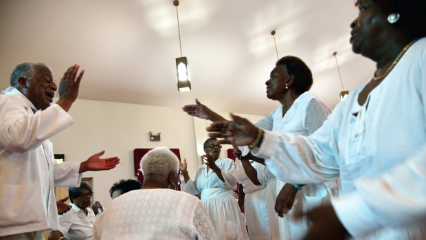 Pastor Jerry Colbert, 64, (left)  the great grand son of a slave, leads a Singing and Praying Band group at the Hall United Methodist Church in Glen Burnie, Maryland.
