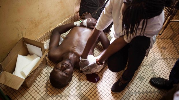 A wounded protester  is treated in hospital in Ouagadougou.
