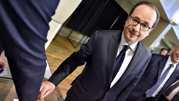 French president Francois Hollande casts his ballot on Sunday.