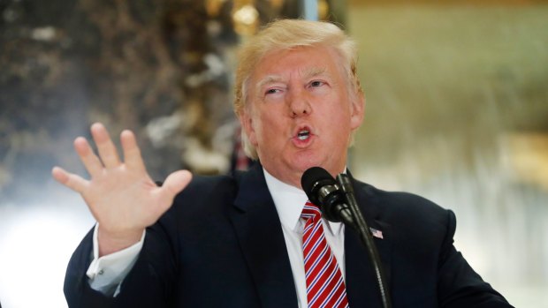 US President Donald Trump speaks to the media in the lobby of Trump Tower in New York.