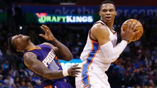 Phoenix Suns guard Eric Bledsoe, left, falls backwards following an offensive foul by Oklahoma City Thunder guard Russell Westbrook, right, in the second quarter of an NBA basketball game in Oklahoma City. 