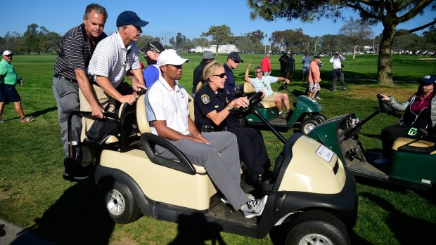 Tiger Woods leaves the course after withdrawing from the Farmers Insurance Open.