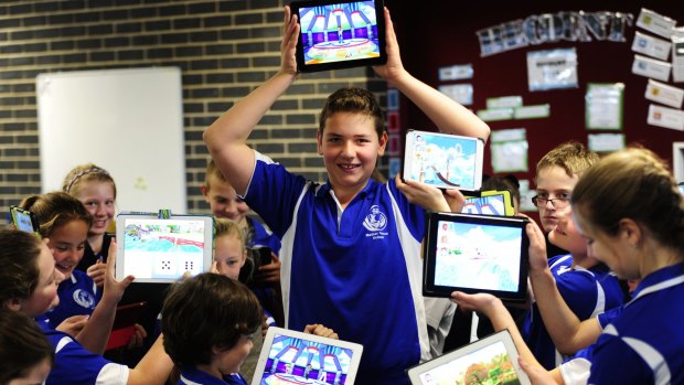 Children in class 6 Ebony led the charge as Mother Teresa Catholic Primary School in Harrison became the first school in the ACT to answer one million questions using Skoolbo. Joshua Drennan,11, celebrated with classmates on Wednesday.
