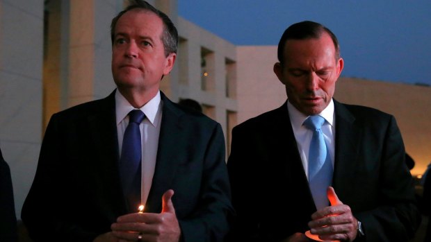 Opposition Leader Bill Shorten and Prime Minister Tony Abbott during a candlelight vigil for Andrew Chan and Myuran Sukumaran on the forecourt of Parliament House in Canberra.