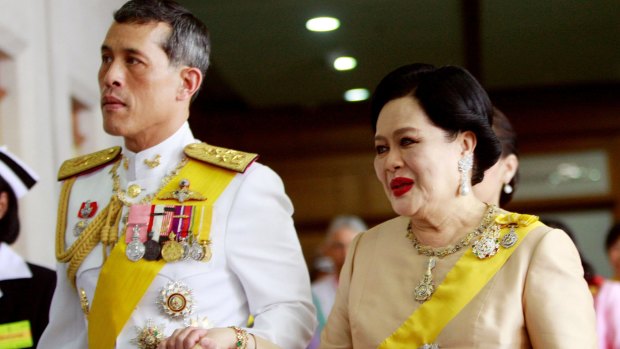 Thai Queen Sirikit walks with her son Crown Prince Vajiralongkorn in 2009.