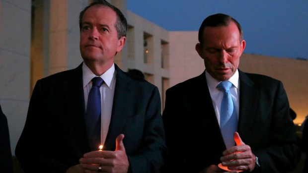 Opposition Leader Bill Shorten and Prime Minister Tony Abbott during a candlelight vigil in February.