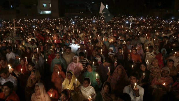 Pakistani Christians hold candles during a vigil for victims of the deadly suicide bombing on Easter Sunday.