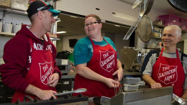 Sean Smith (wearing hat), Patricia Young and Keith Fernandez, working for the dole at the Salvation Army in Auburn, Sydney.