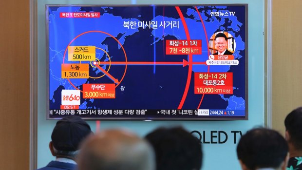 People watch a TV news program reporting a North Korea's missile launch, at the Seoul Railway Station in South Korea.