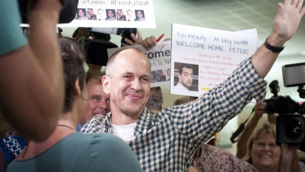 Peter Greste greets supporters on his return to Brisbane. 