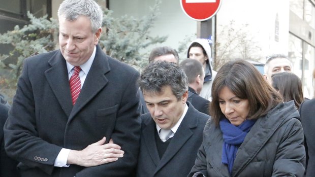 Journalist and doctor Patrick Pelloux (centre), New York City mayor Bill de Blasio and Paris mayor Anne Hidalgo stand united outside the <i>Charlie Hebdo</i> offices in January.