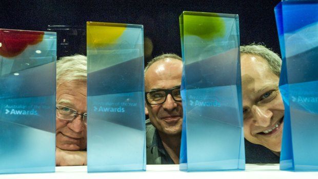 From left, ANU vice-chancellor  Brian Schmidt, head of glassworks Richard Whiteley, and head of music Kenneth Lampl reveal the ANU-designed glass trophies for the Australian of the Year Awards. 