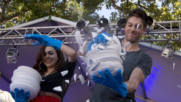 Kelly Paterniti and Lincoln Younes smash plates at the Paniyiri Greek Festival held at Musgrave Park.