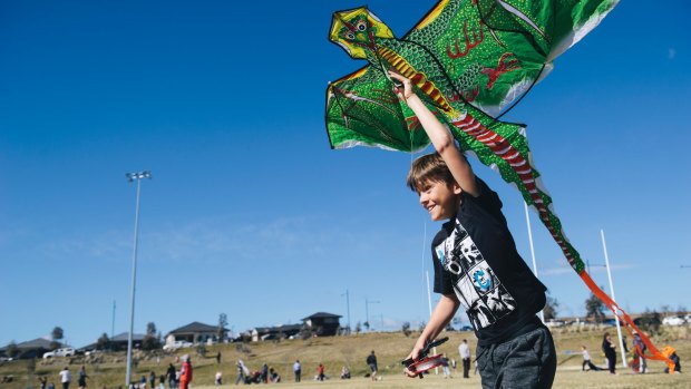 Macca Cleary, 9, of Queanbyean trying to get his kite up despite a lack of wind at Flying High in the Googong Sky on Sunday morning.