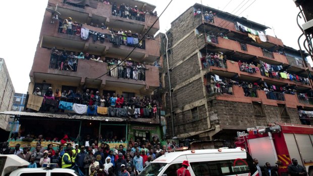 People in Nairobi look at the collapsed building.
