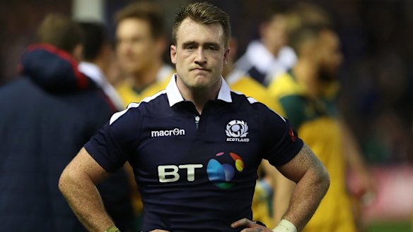 Disappointment: Stuart Hogg watches on as Australia celebrates.
