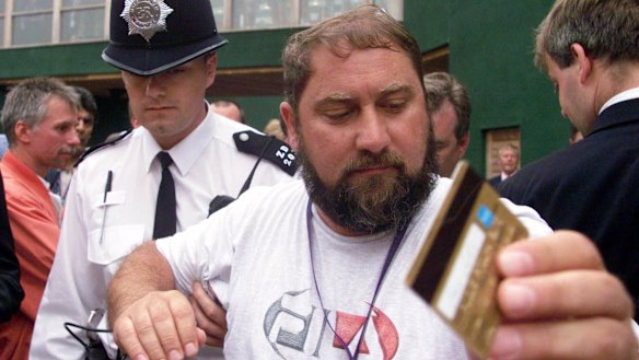 Troublemaker: Damir Dokic, father of Australian tennis player Jelena Dokic, is escorted by police from the media balcony at Wimbledon in 2000.