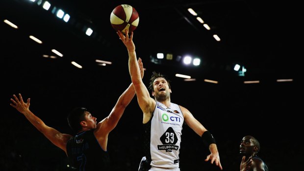 Mark Worthington of Melbourne United lays the ball up against the Breakers.