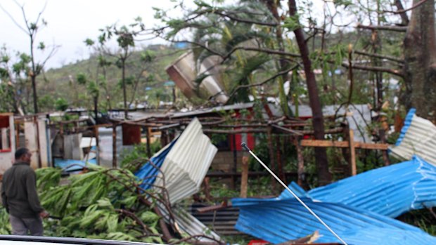 Examining the wreckage in Port Vila.