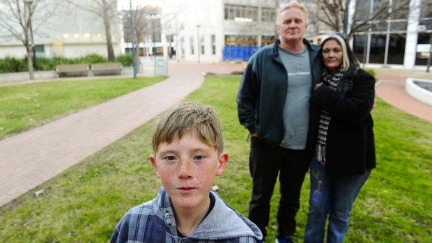 Patrick Hartigan and Joanne Mangan with their son Jack, 11, who is suing the ACT Government after he was mauled by dogs at a Housing ACT property.
