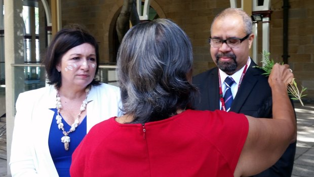 Queensland indigenous MPs Leeanne Enoch (left) and Billy Gordon receive a traditional blessing before they are sworn in at Parliament House..