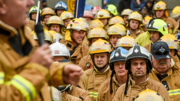 Firefighters rally on the steps of Parliament. 