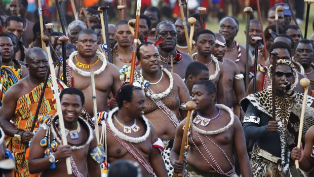 King Mswati III (centre, second row) arrives with his regiments at Ludzidzini royal palace, following the accident that killed dozens of would-be dance participants.