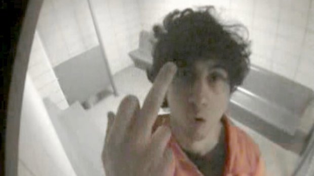 Facing death by lethal injection ... Convicted Boston bomber Dzhokhar Tsarnaev gestures towards a surveillance camera in his holding cell in this 2013 surveillance image released by the US Justice department.