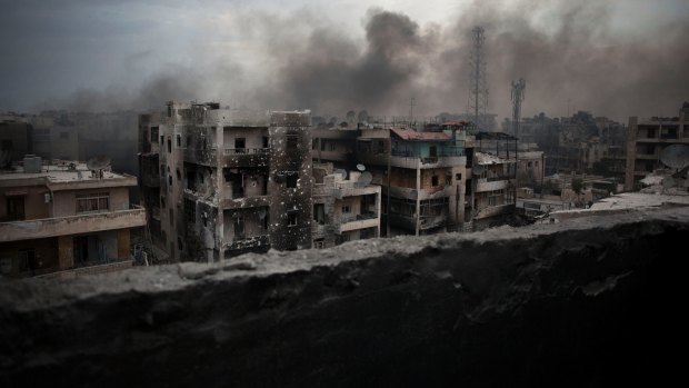 Smoke rises over the Saif al-Dawla district of Aleppo in 2012. 
