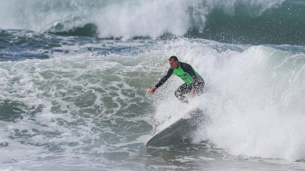 Mr Abbott pictured during a surf competition last year. 