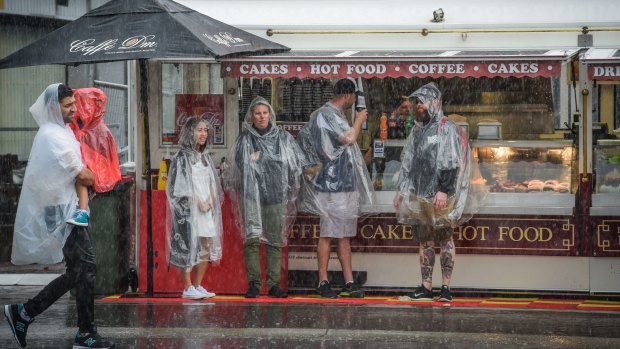 Dampener: Disposable ponchos were the order of the day at a soggy Royal Easter Show on Saturday.