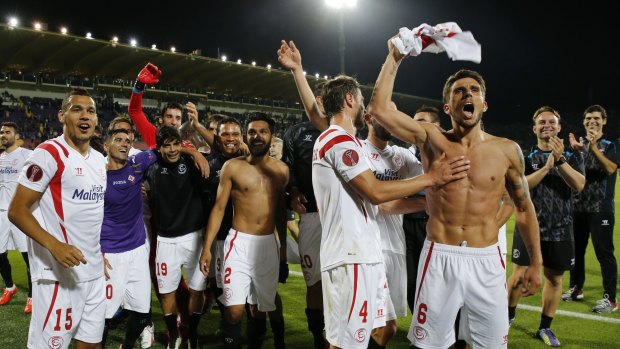 Sevilla players celebrate at the end of the match.