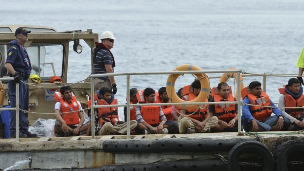 A boat load of asylum seekers arrive on Christmas Island in 2013. Maurice Blackburn is running a class on behalf of detainees.