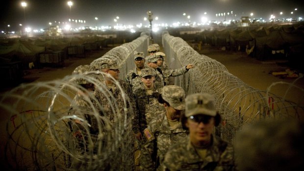 US soldiers patrol Camp Bucca, near the Iraq-Kuwait border, in 2008.