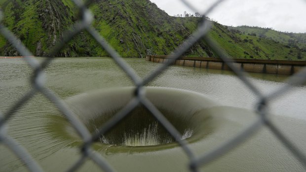 Water flows into the iconic Glory Hole spillway at Monticello Dam.