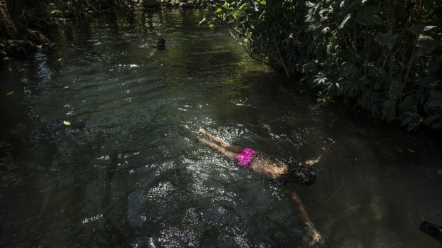 Ixa Auxiliadora Cruz, 8, swims in a stream that feeds into Lake Nicaragua on Ometepe Island.