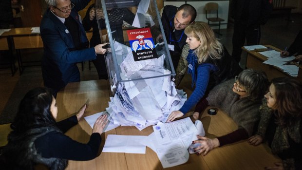 Questionable election: Electoral workers empty a ballot box to start counting ballots for the leadership vote in the self-declared Donetsk People's Republic and Lugansk People's Republic.