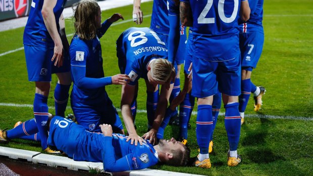 Iceland's players celebrate after scoring against Kosovo.