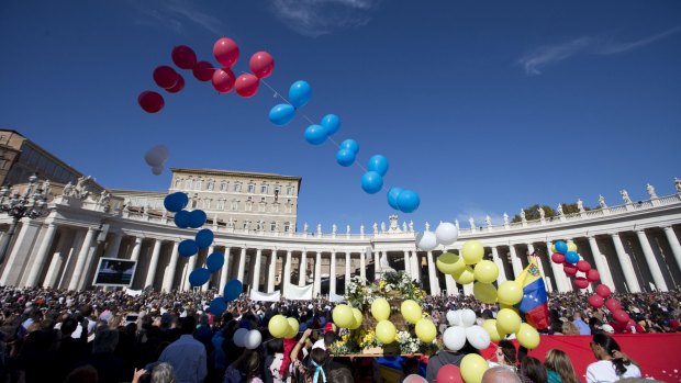 Balloons fly as Pope Francis delivers his Angelus prayer from the studio window overlooking St Peter's Square on Sunday.