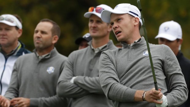 Europe's Danny Willett watches his drive with Team Europe's Justin Rose and Sergio Garcia at practice for the Ryder Cup.