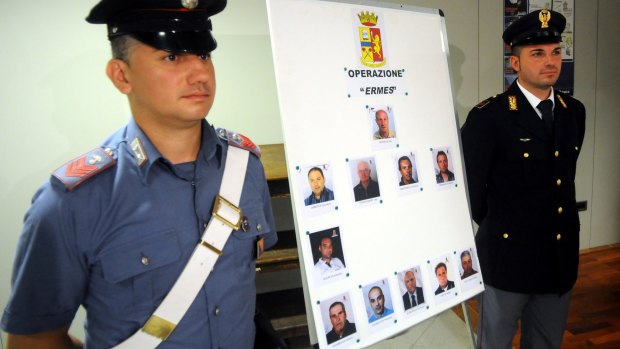 Italian police display mug shots of 11 men suspected of helping Matteo Messina Denaro.