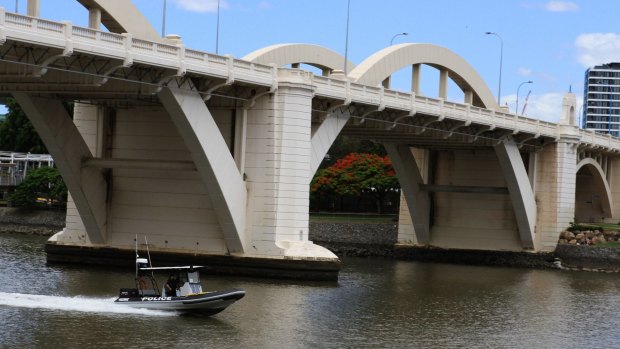 A 16-year-old boy jumped into the Brisbane River while running from police, just metres from where a British tourist disappeared after jumping from the William Jolly Bridge.