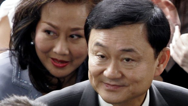 Ousted Thai prime minister Thaksin Shinawatra, front, and his wife Pojaman arrive at criminal court for a verdict in Bangkok in 2008.