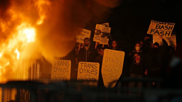 Protestors watch a fire on Sproul Plaza during a rally against Yiannopolous.