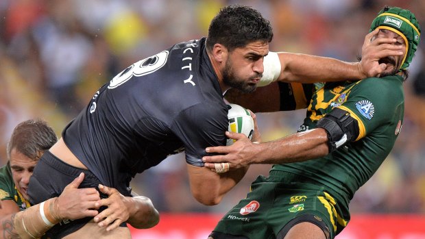 Jesse Bromwich of the Kiwis pushes away Australian superstar Johnathan Thurston during the Anzac Test in Brisbane.